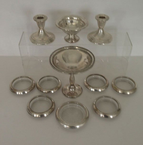 11 Pcs Of Sterling Silver Table Accessories: The weighted candlestick holder, weighted compote, and weighted bowl gross 23.62 ozt. there are 6 glass and sterling coasters and one larger glass and sterling coaster.
