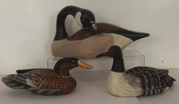 Vintage Goose And Duck Carved Decoys: The lg. Goose measures 8 1/2(H) X 17 1/2(L) X 7(D) inches. The medium sized one that is brown, black, white comes apart in halves and measures 7 1/2 X 15 X 6 1/2 inches. The smaller brown, black and w