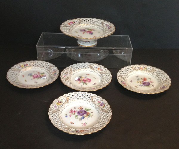 Intimate 5 Piece Meissen Cake Set: Four plates and a compate signed with Meissen crossed sword mark. Plates measure 8.25" diameter. Compote measures 3" tall x 9.25" diameter.