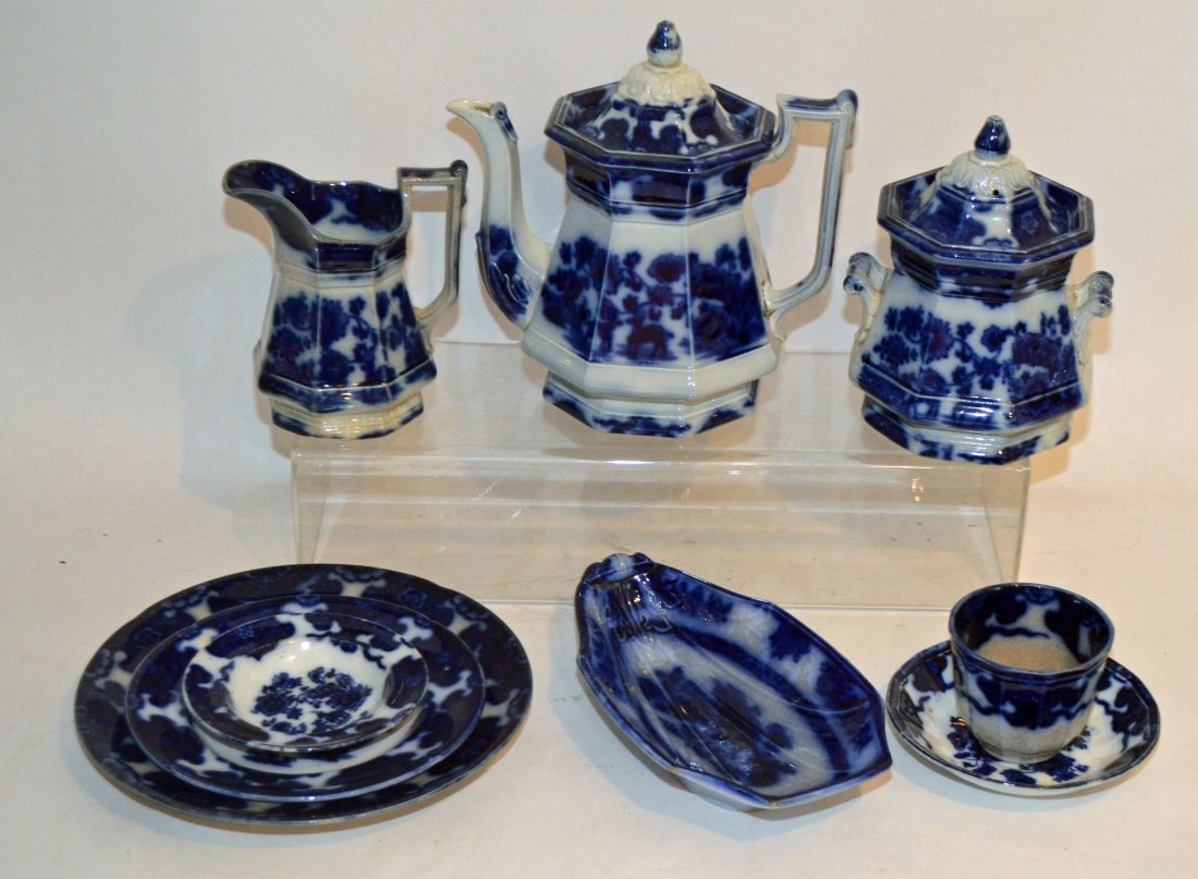 Flow Blue Cashmere Pattern: Lot includes: 9 sauce dishes (5" diameter); 12 saucers (5.75"d); 11 luncheon plates (7.25" d); serving dish (9"l x 5.25"w) ; 13 cups (2.75" tall x 3.25" d); 2 dishes (9.25"d); a cramer (5.75"t); cover