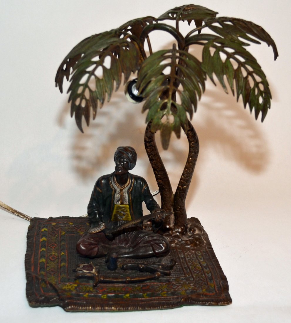 Signed Bergman Vienna Cold Painted Bronze Lamp: Austrian table lamp, seated Arab man on a carpet. Measures 10" tall x 6.5" deep x 8" wide.