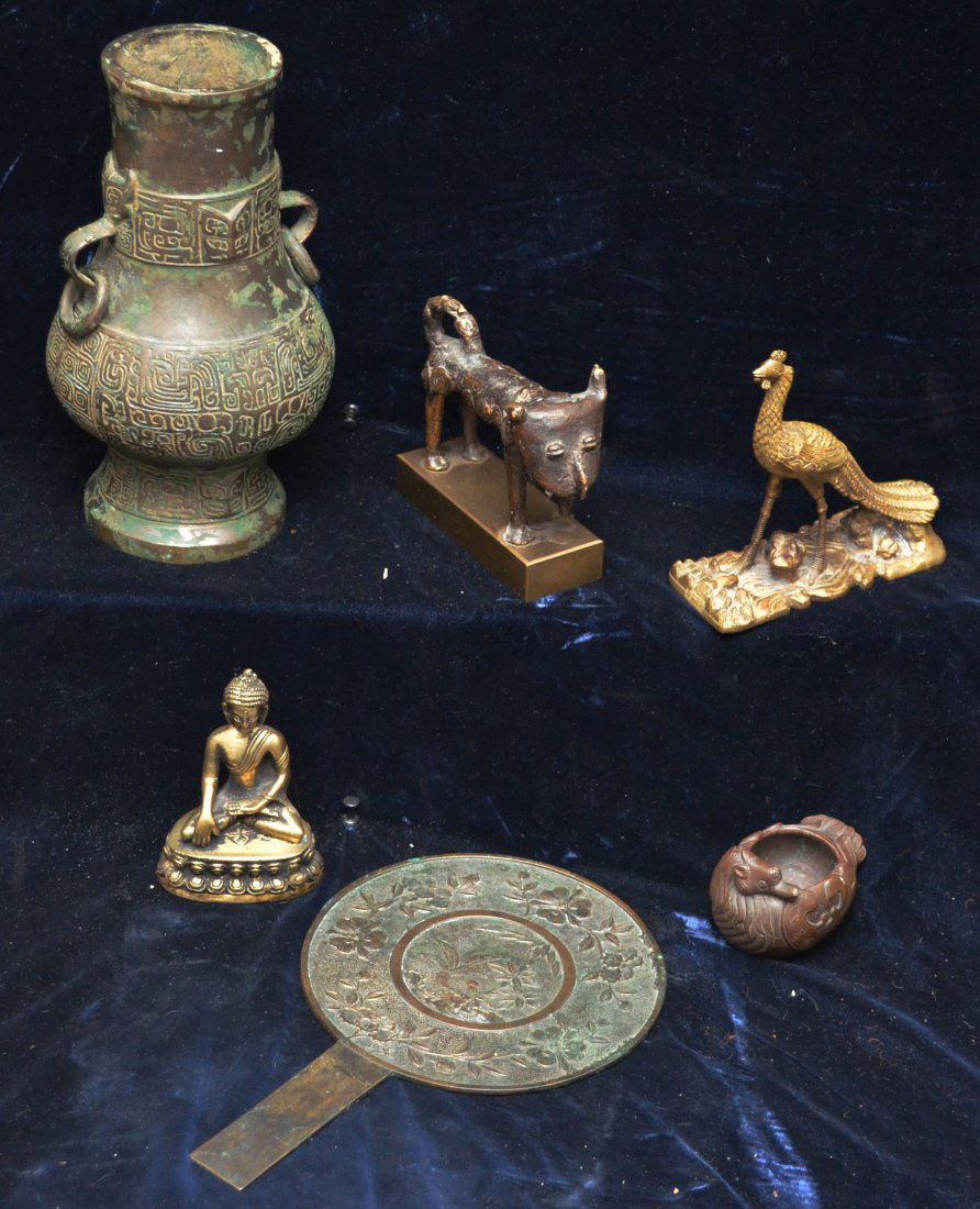 Group of Asian Bronzes and decorative items: The hand mirror measures 5 3/4" in diameter x 9 1/8"(L).The Ostrich measures 4.5"(H) x 4.5"(L) x 1 3/4"(W).The bronze dog measures 3 3/4"(H) x 5"(L) x 1.5"(W). The Buddha measures 3.5"(H) x 2 5/8"(L)