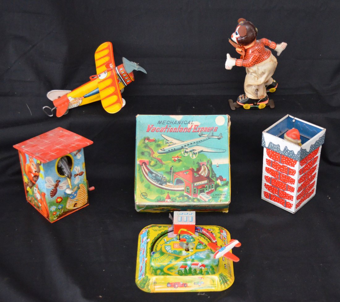 Vintage Tin Toy Lot: Lot includes: Vacationland Linemar toy in original box, Roller skating mouse (6"tall), propeller airplane (7.25"long), Santa Claus in chimney (5"tall) and a birdhouse bank (5.25"tall)