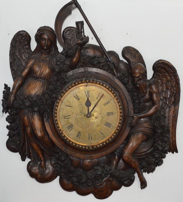 Handsomely Carved Grinling Gibbons Father Time Clock: Late 18th- early 19th century, in the Manner of Grinling Gibbons, England or France. The Beech and Pine case deeply carved with the figure of winged “Father Time” with sickle and a winged “Mothe
