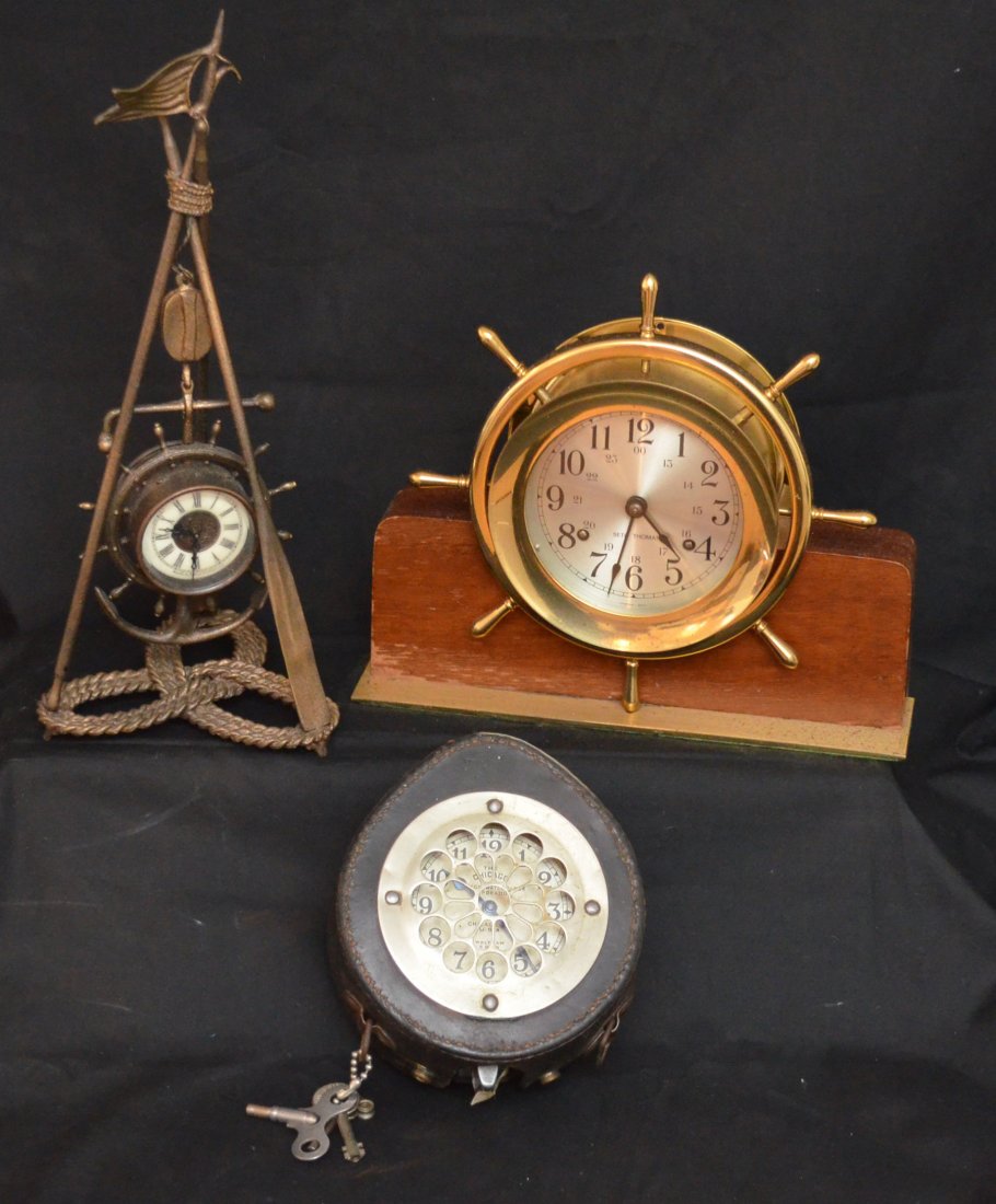 Nice Grouping of 3 Novelty Clocks: Lot includes: The Chicago Watch clock Corp, Waltham 8 day clock in leather case (6" long x 5" diameter x 2.5" deep), Seth Thomas ship's wheel clock on wooden stand (9" tall x 10.5" x 2.5" on base), an