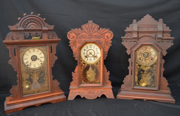 Lot of 3 Gingerbread Clocks (New Haven, Seth Thomas): Lot includes: Seth Thomas with Eastlake Victorian style case (24.5" x 15.5" x 4.75"), New Haven Clock Co CT (22.5" x 13.5" x 4"), and a Victorian style case clock (24.25" x 15.75" x 5" deep)