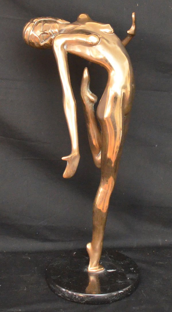 Brass Nude Woman Sculpture Signed Tom Bennett: "Dancin" 1979 Tom Bennett 91/100 brass sculpture on a black marble base. Measures 19 7/8" tall x 6 7/8" diameter at the base.