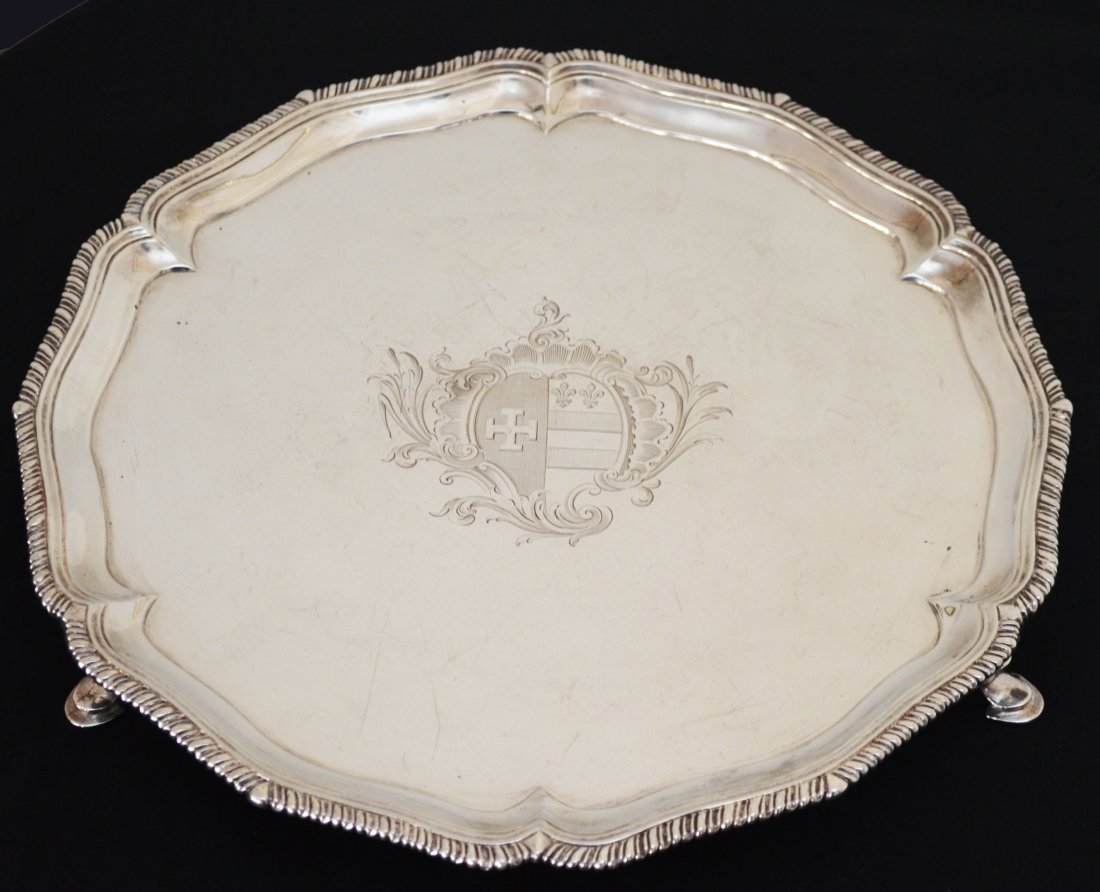 George III Sterling Silver Footed Salver w Crest: Thomas Hannam & Richard Mills circa 1764 (please use your own discretion on the date hallmark as the 1844 mark appears similar). The footed tray measures 1.5" tall x 11.75" diameter and features a cen