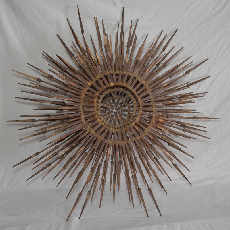 One Of A Kind Iron Primitive Sculpture: Hand forged star or sun sculpture using antique nails, sculpture was taken down from an antique barn. Could be repurposed for lighting. Measures 30" diameter x 8.5" deep.