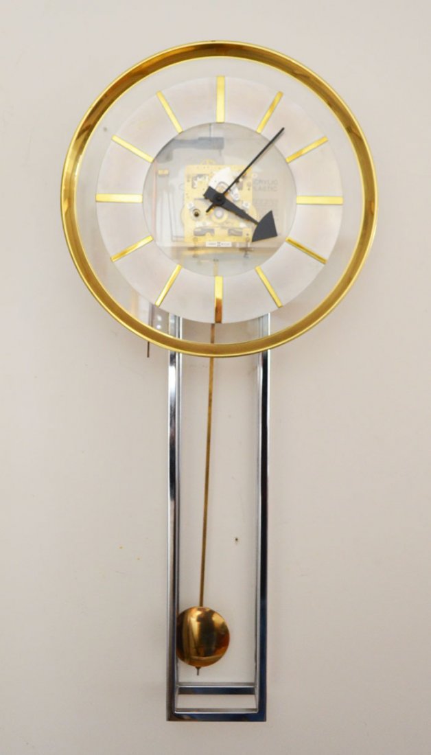 Howard Miller Lucite, Chrome & Brass Wall Clock: Measures 33.25" tall x 15.25" wide x 5" deep.