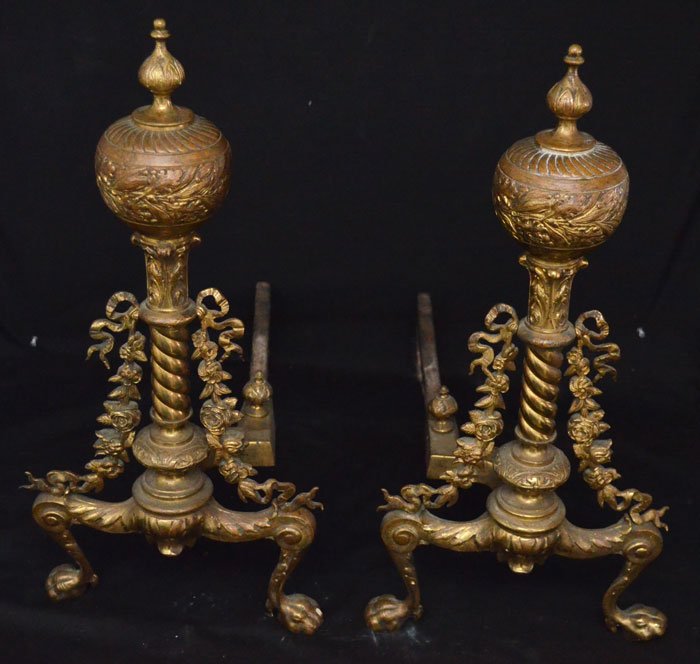 Pair of Ornate French Brass Andirons: Louis XV style andirons with oak leaf motif and garland sides, with paw feet. They measure 21 7/8" tall x 10" wide x 22.5" deep.