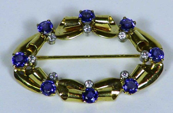 Tiffany & Co. Diamond And Sapphire Pin: This beautiful signed Tiffany & Co.Pin measures 1 7/8" long x 1 1/8" wide It has 8 diamonds and 8 sapphires with great sparkle.
