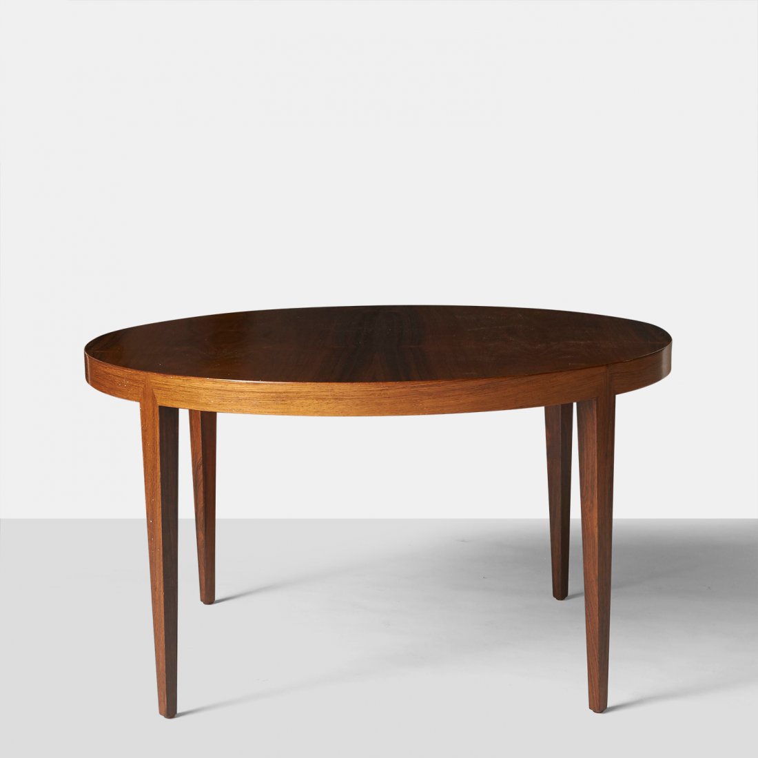 Severin Hansen Jr., Rosewood Coffee Table: For Haslev, a round rosewood coffee table with stiletto legs.Denmark, c1950sDiameter : 35.5" Height : 20"Rosewood