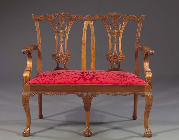 Continental Double Chair-Back Settee,: Continental Double Chair-Back Settee, in the manner of Thomas Chippendale, featuring shaped pierced splats and foliate and floral relief-carved, molded stiles, the shaped straight arms above a single