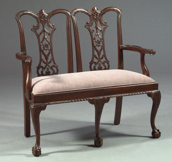 George III Mahogany Double Chair-Back Settee,: George III Mahogany Double Chair-Back Settee, in the manner of Thomas Chippendale, with shaped, pierced shapes each featuring a central circular rosette within a ribbon-carved diamond, the seat padded
