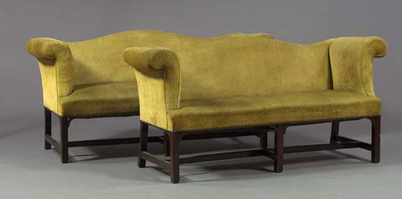 Pair of English Chippendale-Style Mahogany Settees: Pair of English Chippendale-Style Mahogany Camel-Back Settees, late 19th century, each with tall roll-over arms, raised on straight legs joined by stretchers, h. 34", l. 70-1/2", d. 18".