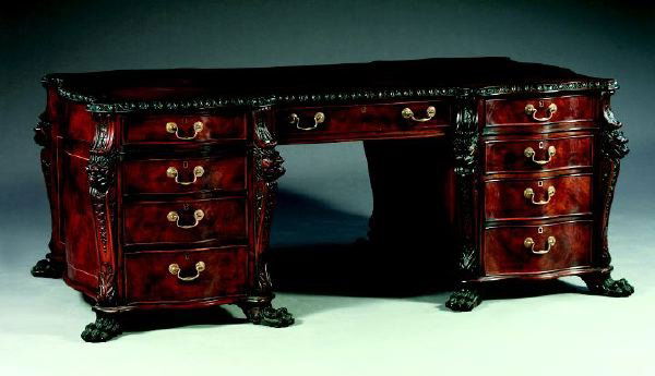 George III-Style Mahogany Partner's Desk: George III-Style Mahogany Partner's Desk, in the manner of Thomas Chippendale (1718-1779), each pedestal containing four graduated cock-beaded drawers of serpentine form with a brass keyhole escutcheo