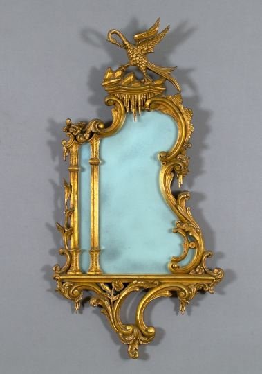 George VI Carved and Antique-Gilded Wood Mirror: George VI Carved and Antique-Gilded Wood Looking Glass, in the English Rococo style of Thomas Johnson (1714-1778), second quarter 20th century, the cresting modeled as a giltwood "dodo" bird, h. 35-1/