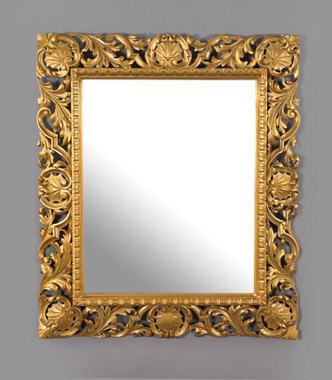 Florentine Scroll-Carved Giltwood Mirror: Florentine Scallop Shell and Scroll-Carved Giltwood Looking Glass, in the Baroque taste, modeled as eight equidistant carved giltwood scallop shells mantled by giltwood foliate scrolls, with a scallop