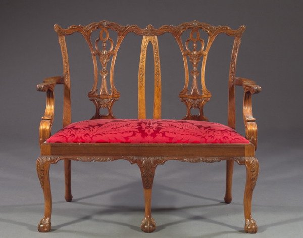Continental Carved Mahogany Chair-Back Settee: Continental Carved Mahogany Double Chair-Back Settee, in the manner of Thomas Chippendale, featuring shaped, pierced splats and foliate- and floral relief-carved, molded stiles, the shaped arms above