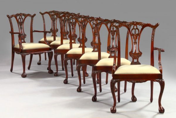 English Highly Carved Mahogany Dining Chairs: Suite of Eight English Highly Carved Mahogany Dining Chairs, in the style of Thomas Chippendale, comprising a pair of master's chairs, h. 39-3/4", w. 22-3/4", d. 24", and six sidechairs en suite, each