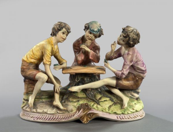 Large Italian Antique-Glazed Porcelain Group: Large Italian Antique-Glazed Porcelain Group of Three Children Playing Cards, and two of them cheating!, second quarter 20th century, h. 11-1/2", w. 15-1/2", d. 8".