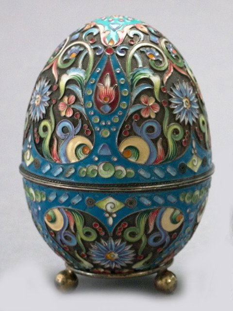 Russian Enameled Silver and Silver-Gilt Easter Egg: Russian Enameled Silver and Silver-Gilt Easter Egg, in the Antique Russian style, 1899-1908, by Pavel Ovchinnikov and so hallmarked, the interior gilded, presented on a period silver-gilt annular ball