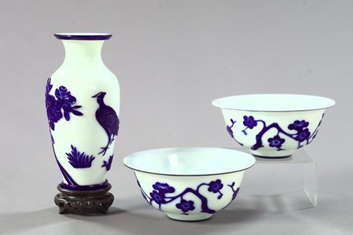 Three-Piece Group of Peking Glassware,: Three-Piece Group of Peking Glassware, fourth quarter 19th century, consisting of a pair of blue and white cameo-cut Peking glass bowls in "Prunus" decor, h. 3", dia. 6-3/4", and a similar blue and wh