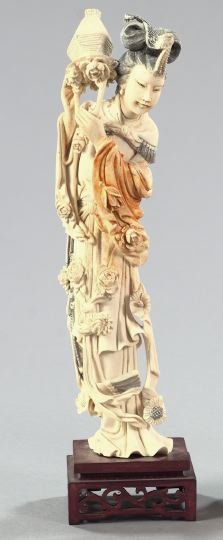 Chinese Carved and Tinted Tusk Ivory Figure: Chinese Elaborately Carved and Tinted Tusk Ivory Figure of a Female, in the Ch'ien Lung style, the elaborately robed figure depicted turning over a basket of chrysanthemums, presented on a square fret
