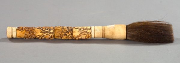 Chinese Carved, Calligrapher's Brush: Large Chinese Carved, Antiqued and Polished Bone-Mounted Badger Hair Calligrapher's Brush, in the traditional style, the bone shank carved with fish and aquatic plants, h. 17-1/2", w. 1-12/3", d. 1".