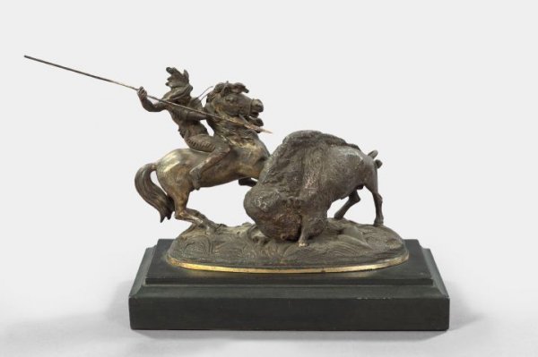 American Parcel-Silvered Tabletop Group: Attractive American Parcel-Silvered and Bronze-Patinated Tabletop Group, fourth quarter 19th century, depicting a mounted Indian preparing to lance a charging buffalo, presented on an oblong matte-fin