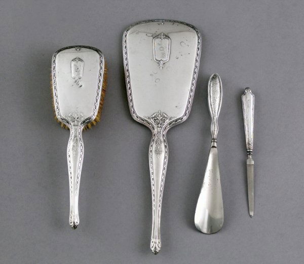 Lady's Dressing Table Accessories: Assorted Five-Piece Group of Lady's Dressing Table Accessories, consisting of a two-piece American sterling silver long-handled hand mirror and matching hairbrush, first quarter 20th century, mirror l