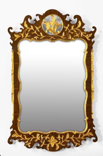 Edwardian Carved and Parcel-Gilt Mahogany Mirror: Elegant Edwardian Carved and Parcel-Gilt Mahogany Looking Glass, first quarter 20th century, in the George II style, the cresting modeled as a pierced circle centered by a carved giltwood acanthine sp