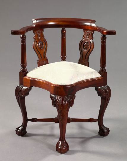 George III-Style Mahogany Corner Chair,: George III-Style Mahogany Corner Chair, the rounded and back-scrolled crest above two pierced foliate-carved splats, the shaped and padded seat raised on cabriole legs headed by foliate carving and en