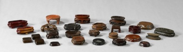 Chinese Carved Wooden Display Stands: Group of Twenty-Six Chinese Carved Wooden Display Stands, for figural groups, several with conforming surfaces, all in various woods, the smallest l. 2-1/2", w. 2-1/4", the largest dia. 4-1/2".