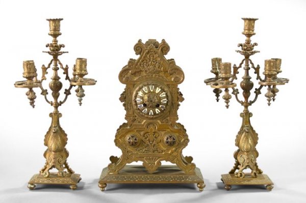 French Bronze-Patinated Brass Mantel Garniture: Good Three-Piece French Bronze-Patinated Brass Mantel Garniture, fourth quarter 19th century, in the Neo-Grec taste, the set consisting of a mantel clock with black Roman chapters on white enamel shie