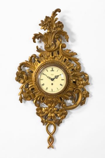 Smith's, England, Carved Giltwood Wall Clock,: Smith's, England, Carved Giltwood Wall Clock, second quarter 20th century, in the Louis XV taste, the white dial signed "Smith's/7 Jewels/8 Day" and fitted with a convex glass cover, h. 31", w. 16".