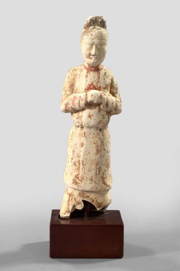 T'ang Dynasty Polychromed White Clay Tomb Figure: T'ang Dynasty Polychromed White Clay Tomb Figure, 618-906 A.D., depicting a robed attendant, presented on a mahogany block base, the period polychromy generally worn, h. 12-1/4".