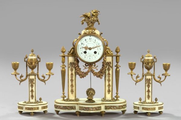 Au Vase de Sevres, Paris, Marble Mantel Garniture: Good Three-Piece Au Vase de Sevres, Paris, Carrere Marble Mantel Garniture, fourth quarter 19th century, with gilt-brass mounts in the Louis XVI taste, comprised of a mantel clock of portico form, h. 