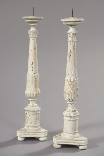 Pair of Italian Provincial Pine Pricket Candlestic: Pair of Italian Provincial Pine Pricket Candlesticks, second quarter 19th century, turned, carved and painted white in the neoclassical style, each supported on a trio of bun feet, each drip pan cente