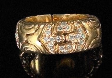 Gold and Diamond Bulgari Lady's Ring: Eighteen-Karat Gold and Diamond Bulgari Lady's Ring, of spring-opening design with interlocking geometric forms with three panels inset with sixty round brilliant-cut diamonds.