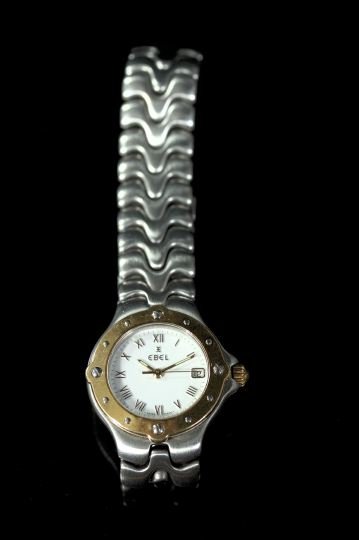 Gold and Stainless Steel Wristwatch: Lady's Eighteen-Karat Yellow Gold and Stainless Steel Wristwatch, Sportwave model, the white enamel face with eighteen-karat yellow gold bezel and a sculptured stainless steel bracelet.