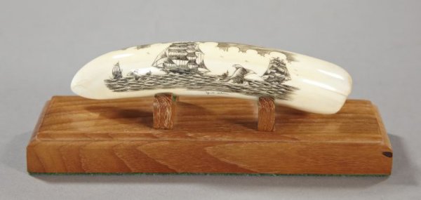 Yiet Shon-Signed Engraved and Oxidized Scrimshaw: Yiet Shon-Signed Engraved and Oxidized Scrimshaw Walrus Tusk, the tusk featuring an attractive 19th-century whaling scene, presented on a custom oblong mahogany display stand, l. 6".