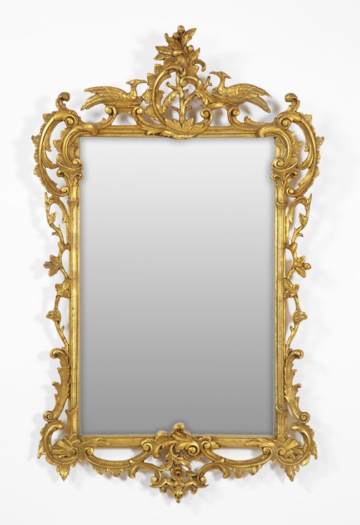 George V Carved Giltwood Looking Glass,: George V Carved Giltwood Looking Glass, second quarter 20th century, in the rococo style of Thomas Chippendale, the tall cresting modeled as an upright leafed giltwood foliate scroll flanked by a pair