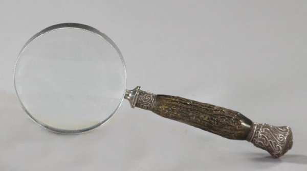 Edwardian Silver-Mounted Black Horn Desk Magnifier: Edwardian Silver-Mounted Black Horn Desk Magnifier, first quarter 20th century, in the Art Nouveau style, the silver mounts patterned with bas-relief Art Nouveau "whiplash" curves", l. 10-1/2".