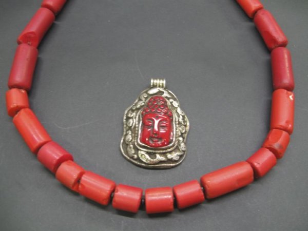 Coral Necklace and Pendant Drop,: Coral Necklace and Pendant Drop, the necklace a dramatic Nepalese coral example composed of twenty-two tubular beads of red coral of varying lengths with a brass screw clasp, l. 24"; the drop a Tibeta