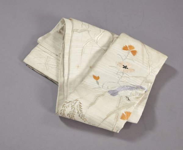 Good Japanese Taisho Silk Damask Winter Obi,: Good Japanese Taisho Silk Damask Winter Obi, first quarter 20th century, the metallic gold, coral, mauve and gray embroidered ivory obi in "Crested Bird and Flowering Bough" decor, w. 6", l. 130".