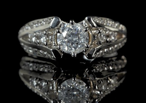 Gold and Diamond Lady's Engagement Ring: Fourteen-Karat White Gold and Diamond Lady's Engagement Ring, composed of a central prong-set round brilliant-cut diamond weighing .70 carats and further set with forty round brilliant-cut diamonds se
