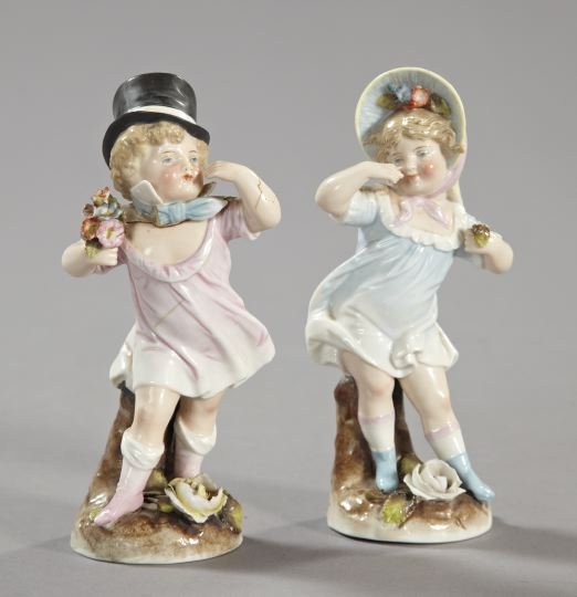 Two Continental Porcelain Figures,: Two Continental Porcelain Figures, first quarter 20th century, one an amusing "Dresden" porcelain figure of an infant soubrette in a top hat; and the other a similar figure of a windswept bonneted gir