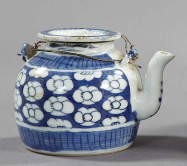 Chinese Provincial Porcelain Teapot: Chinese Provincial Blue and White Porcelain Teapot, third quarter 19th century, of small size in "Prunus Blossom" decor, retains the period circular dished porcelain cover and the double arched wire h